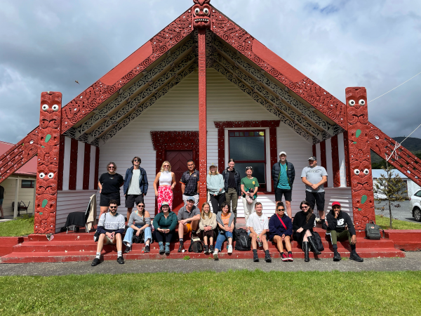 Group of people posing for photo at a Marae