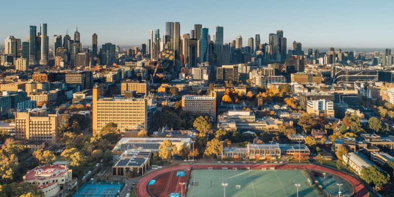 Drone view overlooking the Parkville campus and sports precinct towards the city of Melbourne