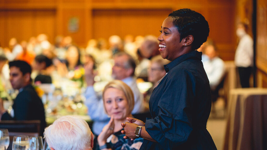 Kamaka Martin stands and smiles at an event following a career announcement.