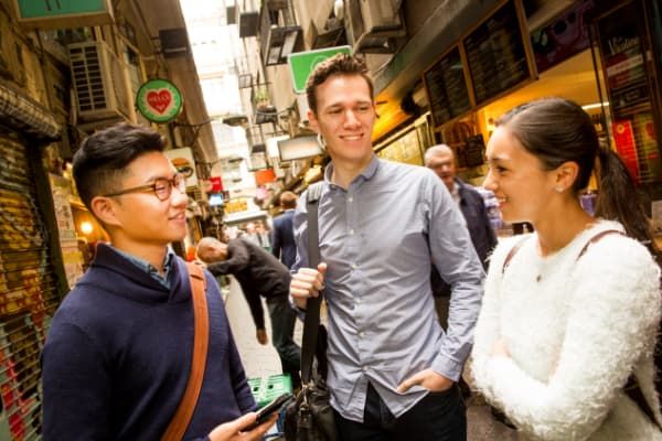 three students chatting in a laneway in Melbourne CBD